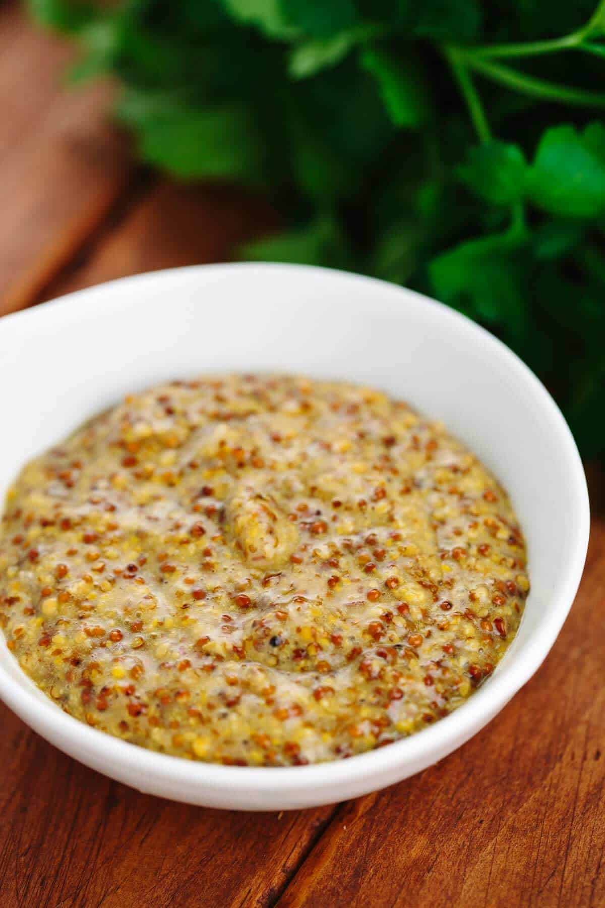 Mustard, beer, and honey sauce in a white bowl.