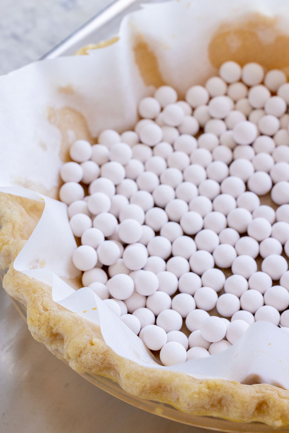 Pie crust with pie weights and parchment paper.