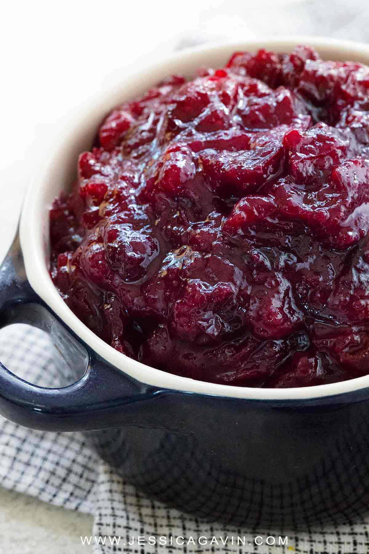 A Thanksgiving holiday feast is not complete unless there is homemade cranberry sauce on the table! Make this easy four-ingredient condiment ready in under 30 minutes. #thanksgiving #cranberrysauce #cooking #cranberry #vegan
