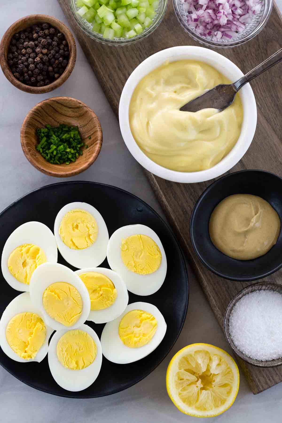 Egg salad recipe pre-portioned ingredients on a table.