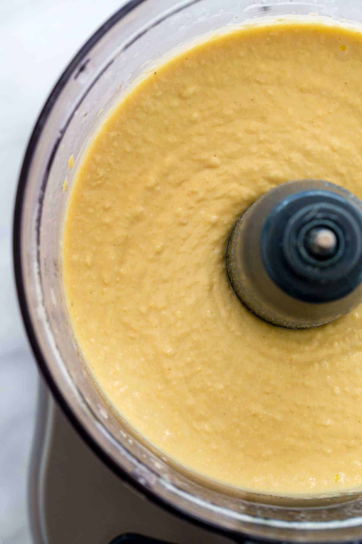 Smooth homemade hummus in a food processor.