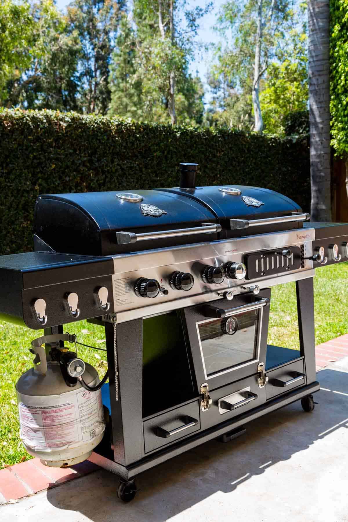 Pit Boss Memphis Ultimate grill, a three-in-one outdoor cooking station with gas grill, charcoal grill, and electric smoker.