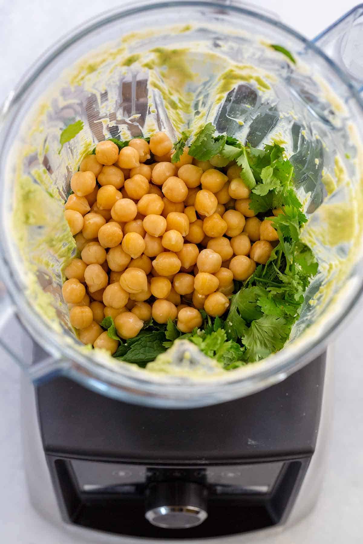 Chickpeas inside the container of a blender.