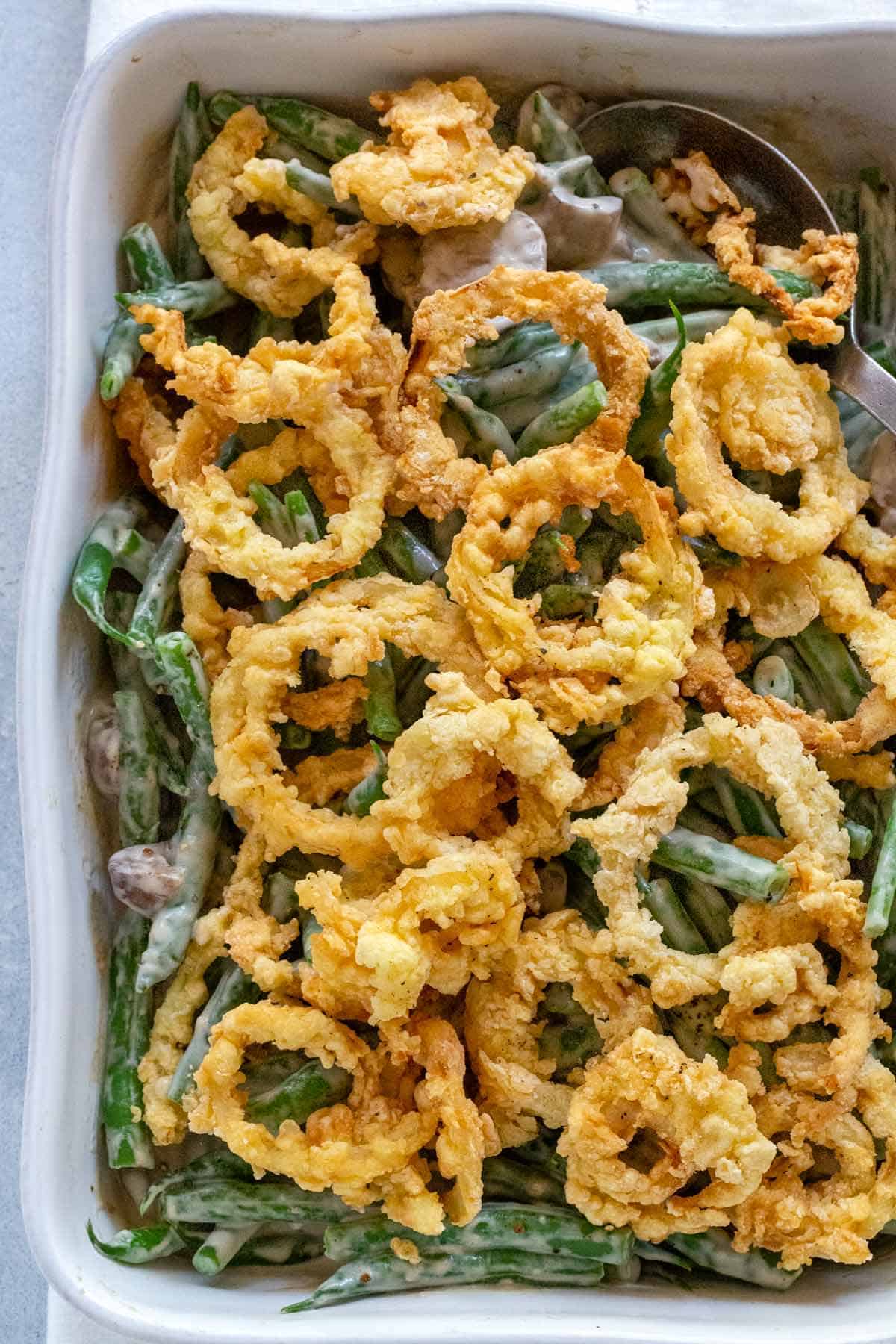 Green bean casserole with fried onion rings on top.