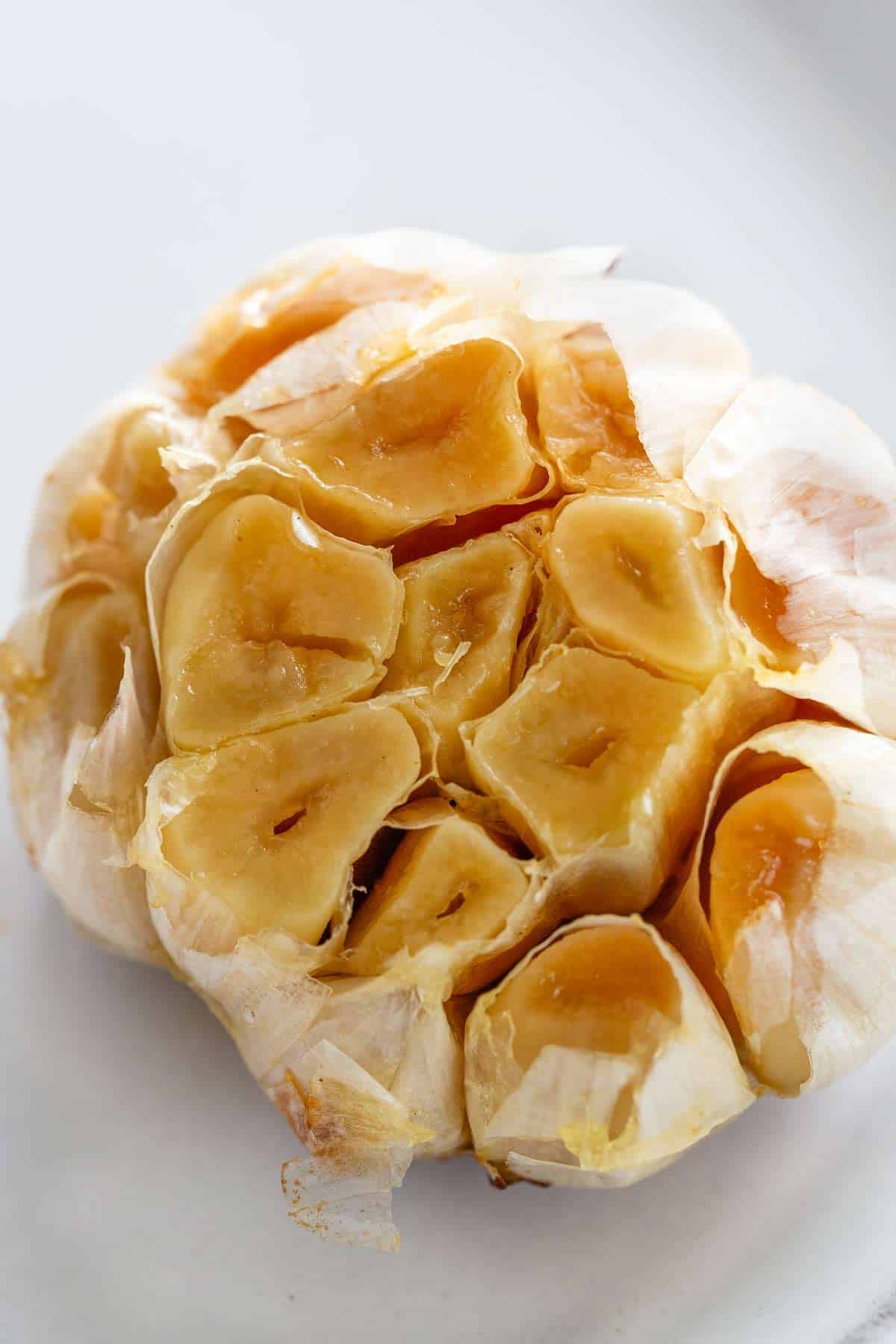 Roasted garlic clove with the top cut off.