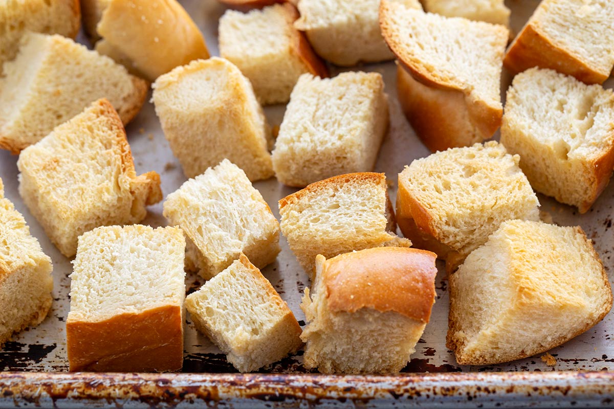 Cubes of toasted bread on a baking sheet.
