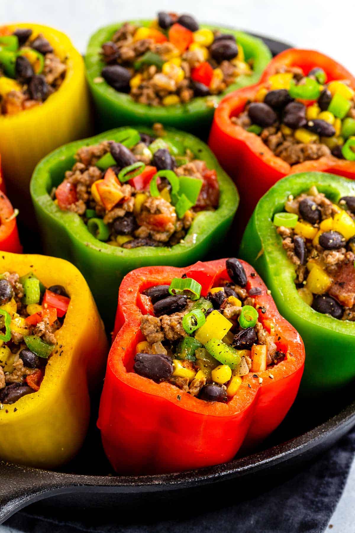 Colorful bell peppers filled with ground beef and beans.
