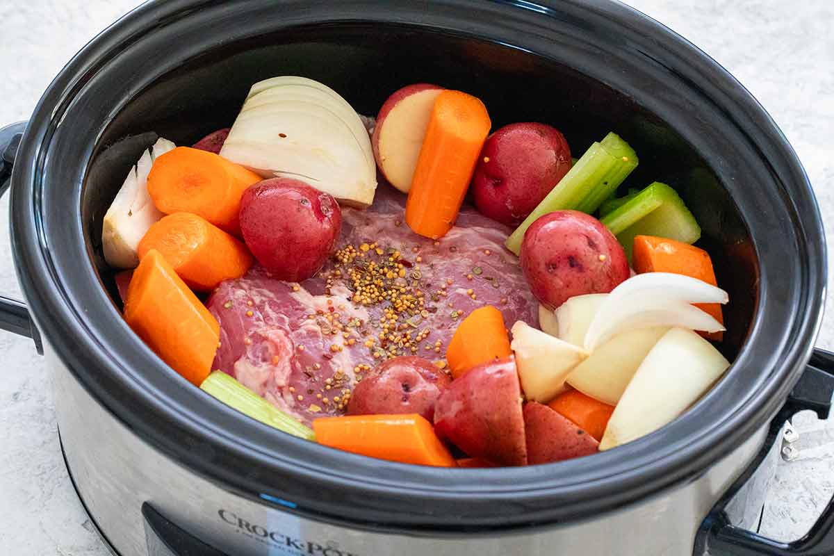 Corned beef and vegetables inside a Crock-Pot.