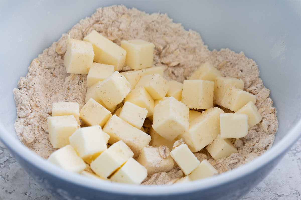 Cubes of butter in a bowl with flour.