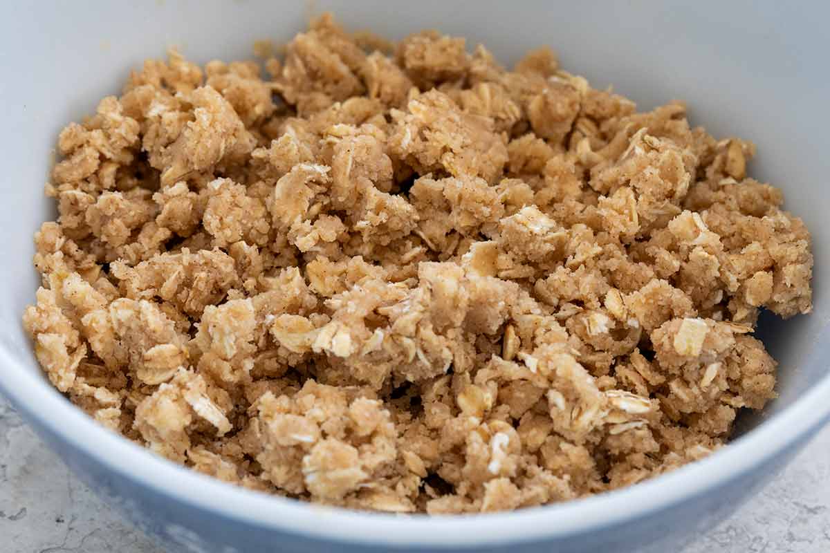 Oat mixed with butter and sugar inside a mixing bowl.