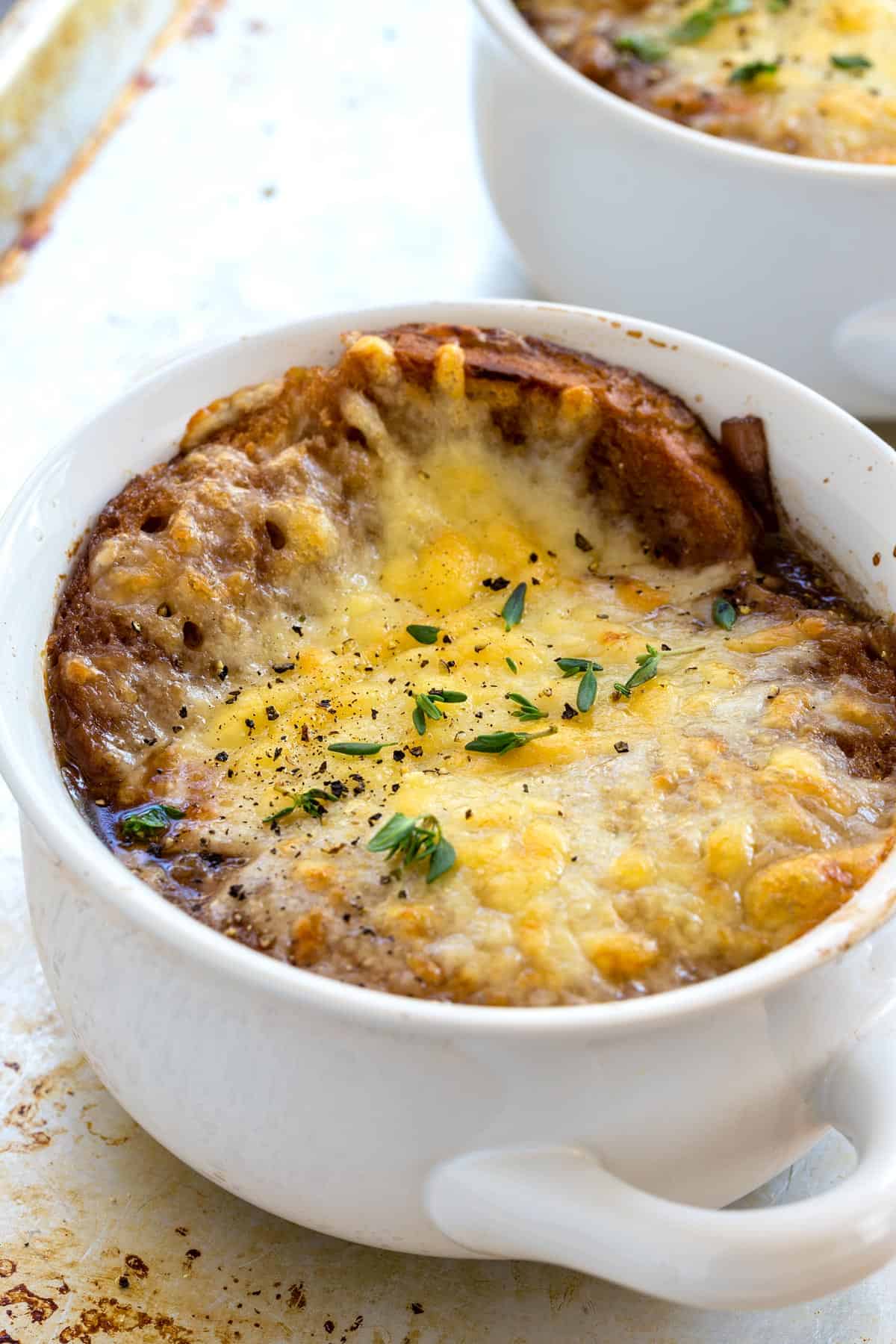 A bowl of French onion soup with a melted, golden brown cheese topping.
