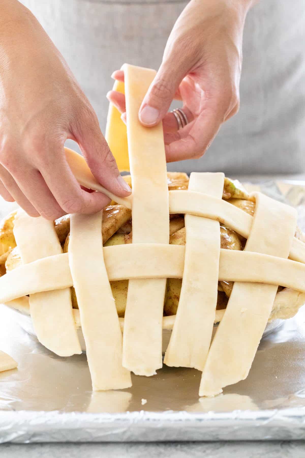 Weaving strips of dough together.