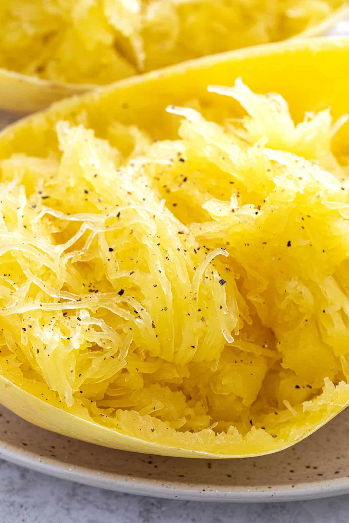 Strands of spaghetti squash on a plate.