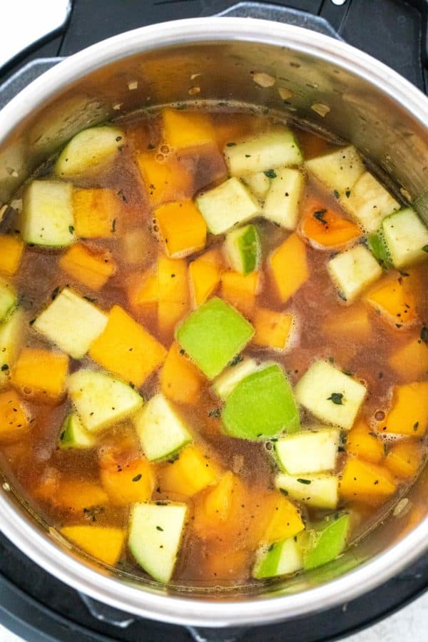 Top down view of green apples and butternut squash cooking inside the Instant Pot.
