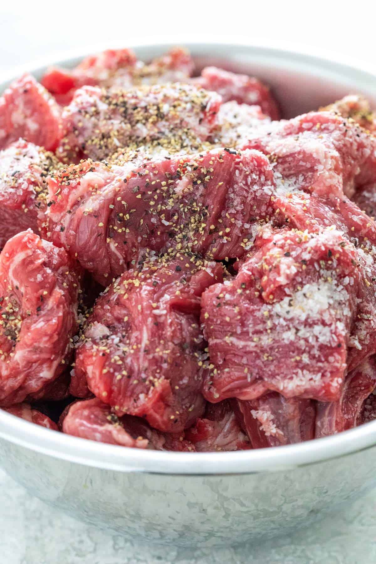 seasoned beef chuck in a mixing bowl