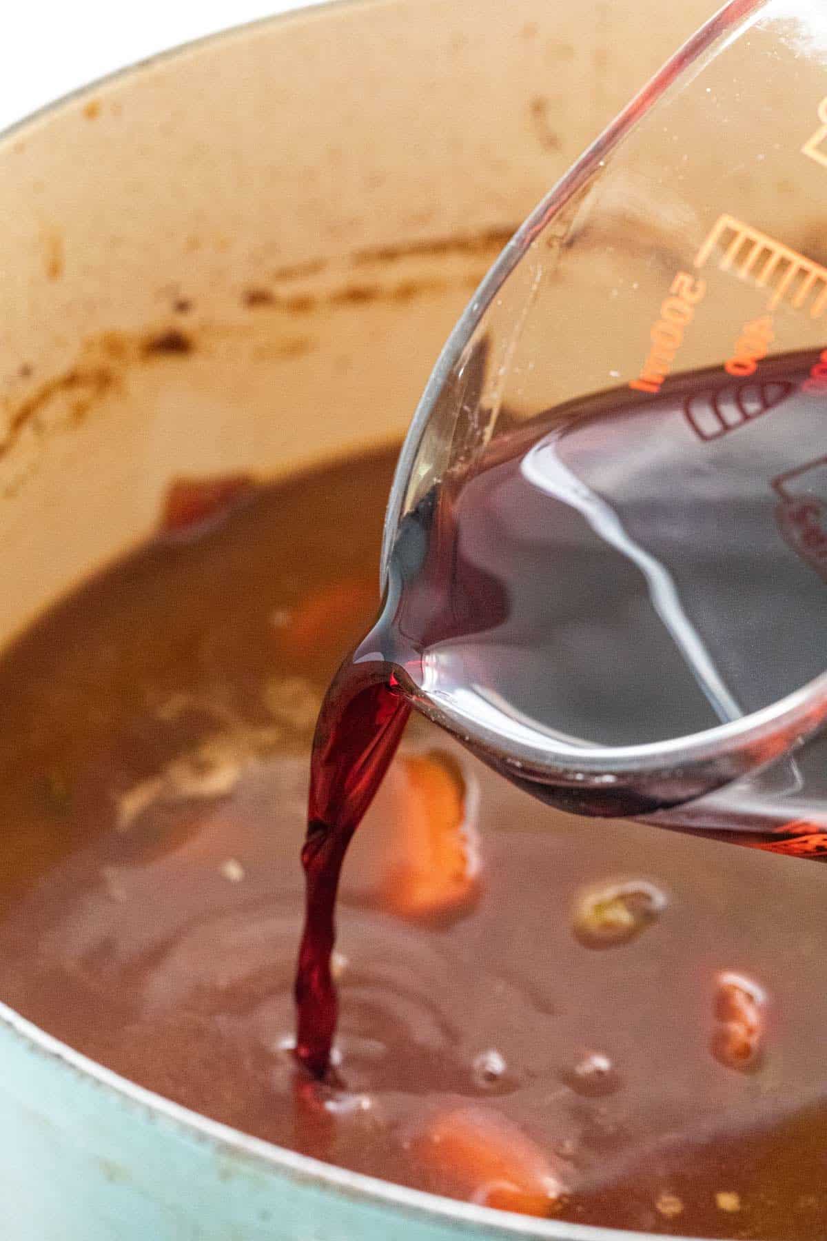 Pouring wine into a pan