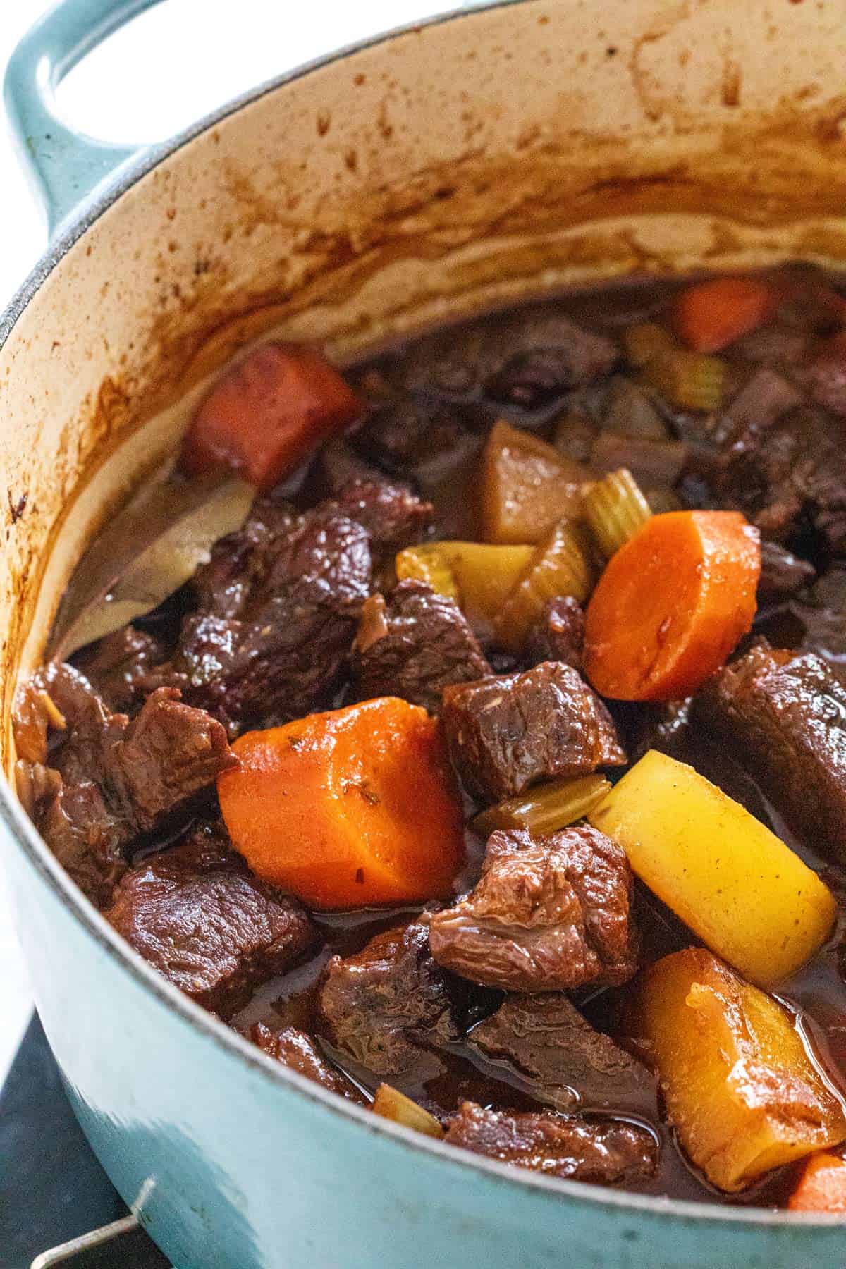Cooking beef stew in a large pot.