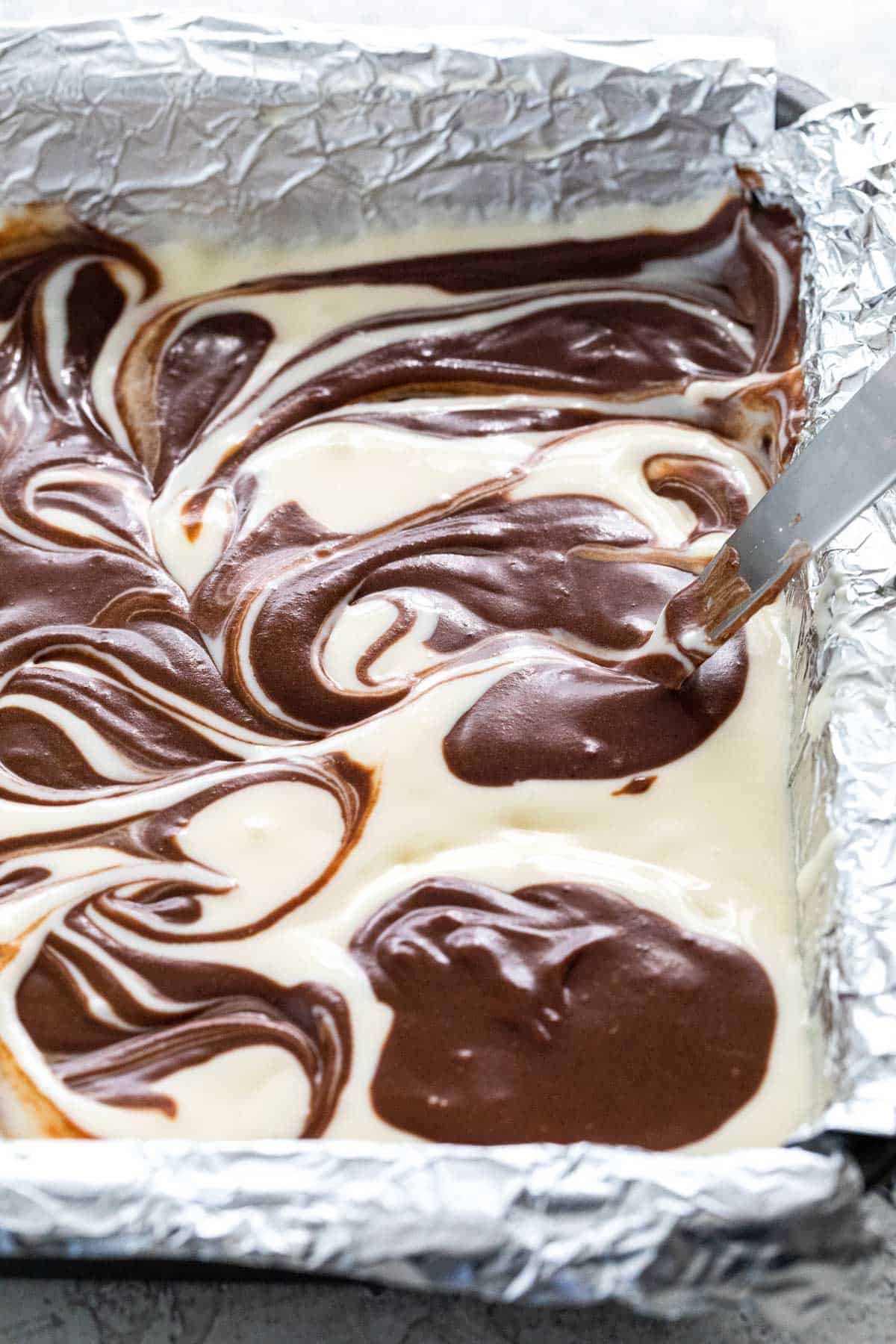Making swirl designs on the brownie topping.