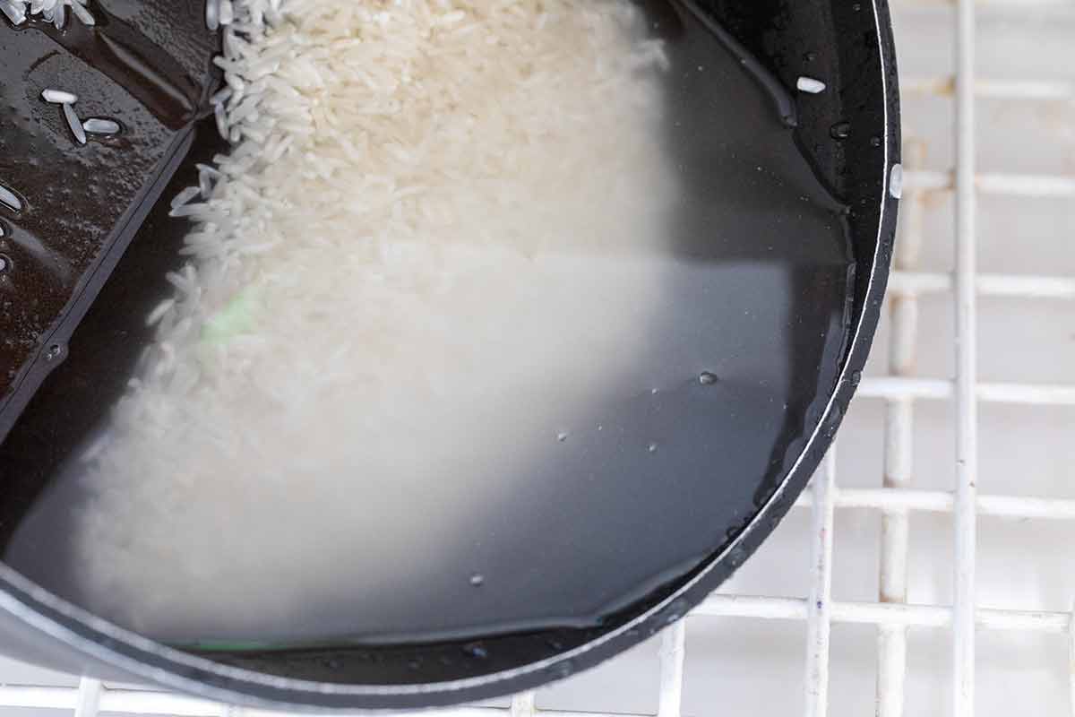 Starch from rice grains released into pot of water.