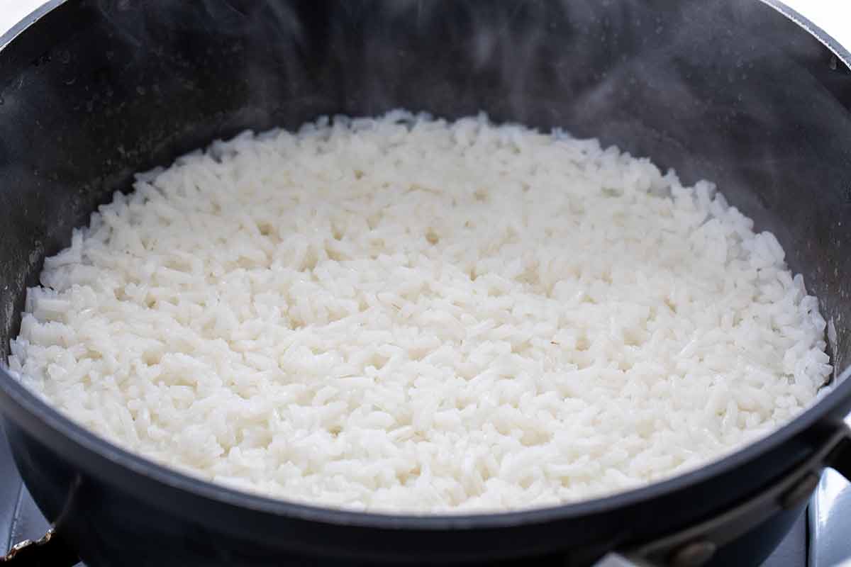 White rice cooking in a saucepan.