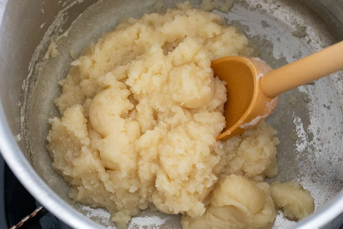 Vanilla paste being cooked and stirred in a pot.