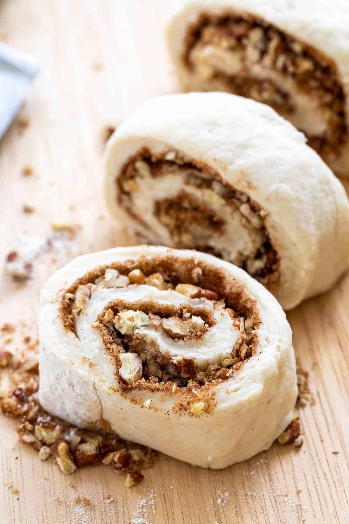 Portioned sticky bun dough swirl before baking.