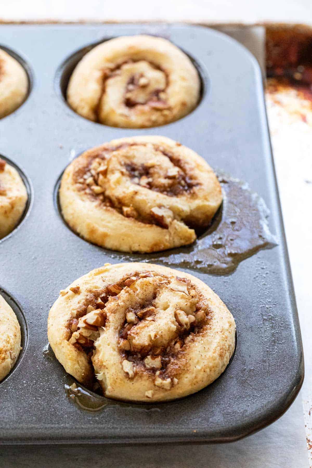 Sticky buns in a muffin pan after baking.