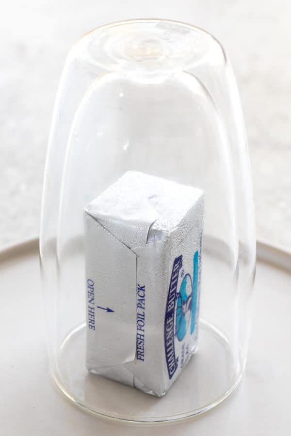 stick of butter under a glass cup