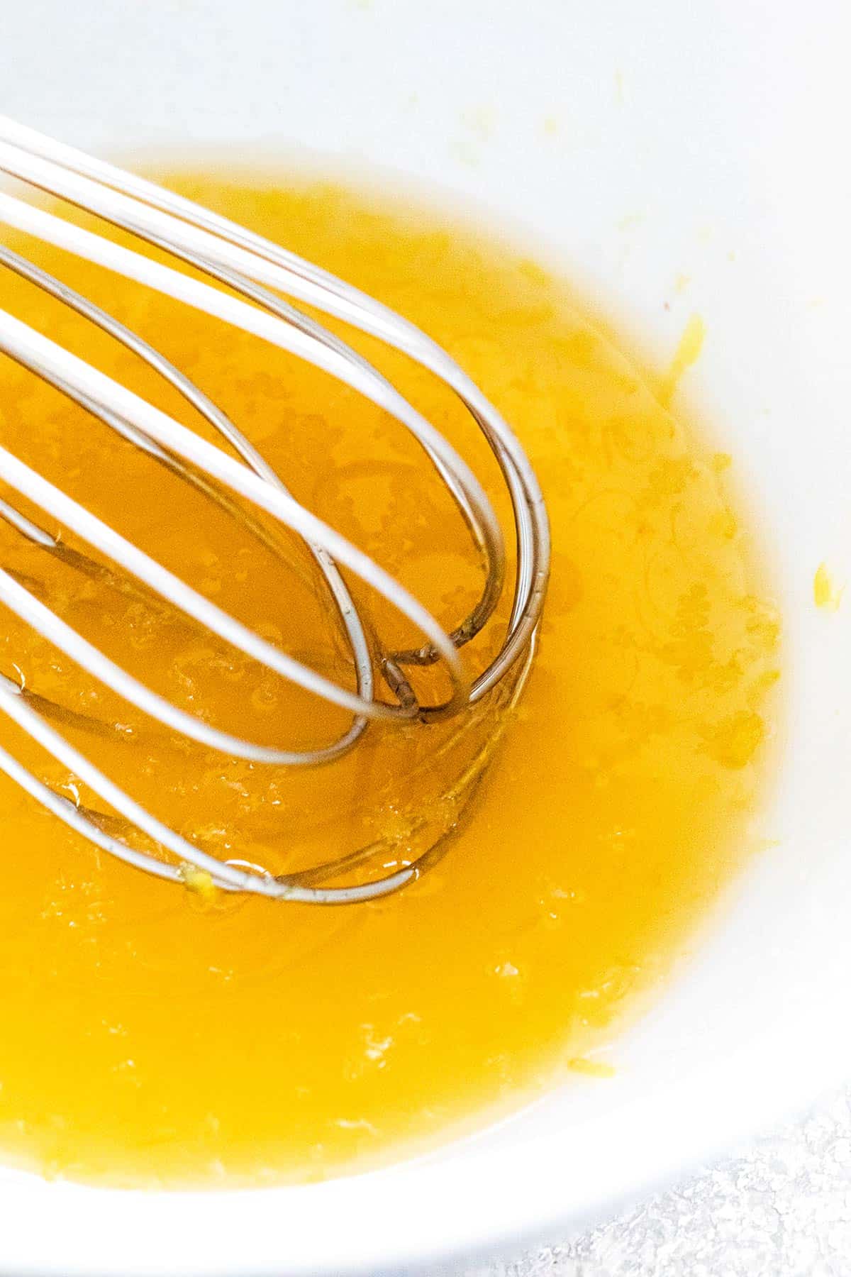 Whisking a bowl of honey lemon dressing.