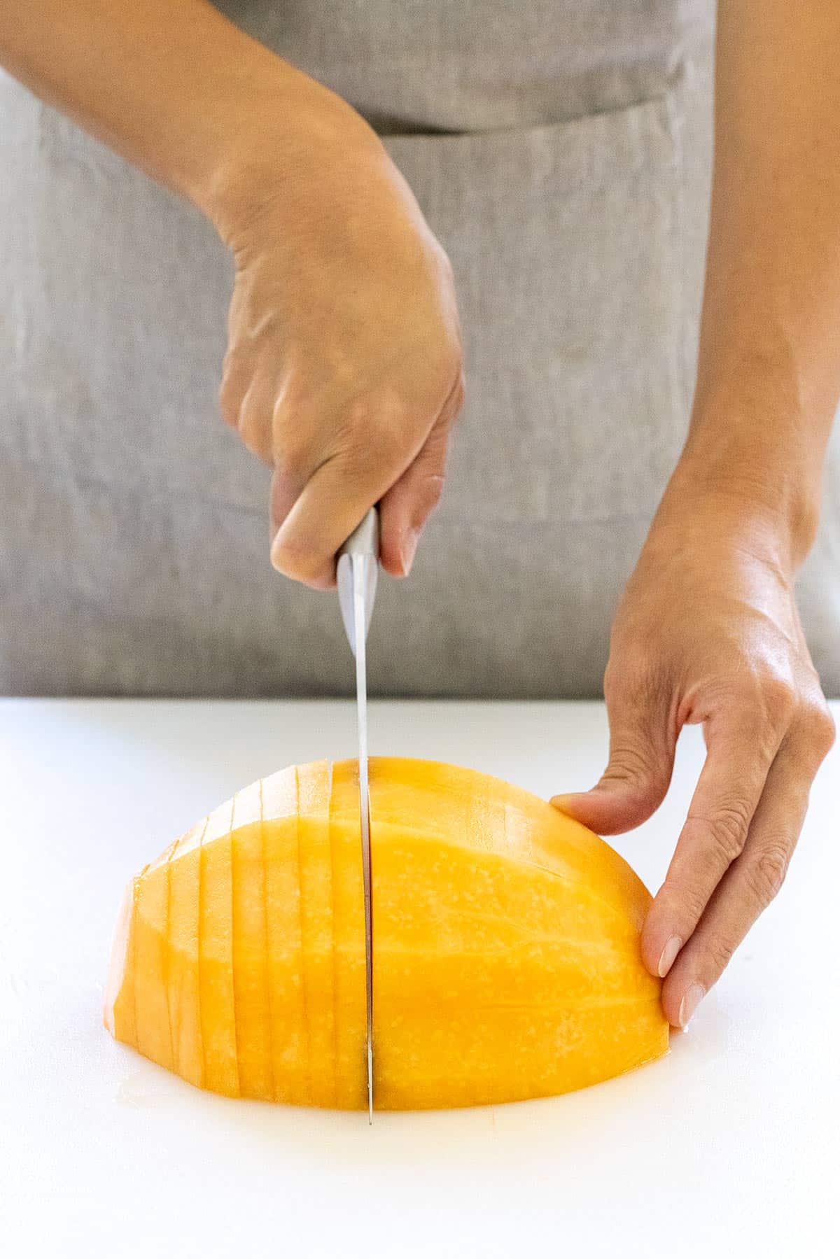 Slicing a melon into thin pieces.