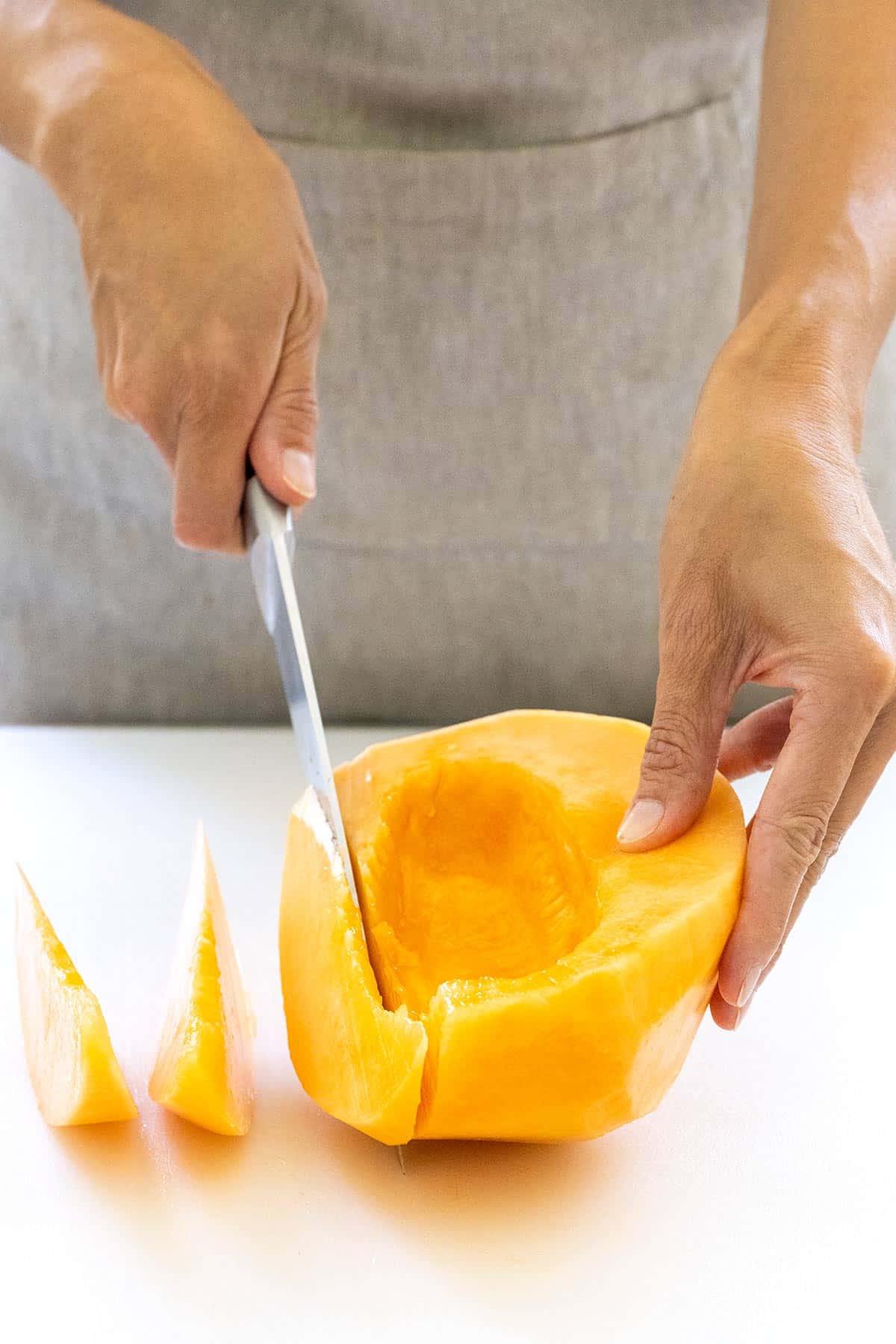 Cutting a cantaloupe into wedges.