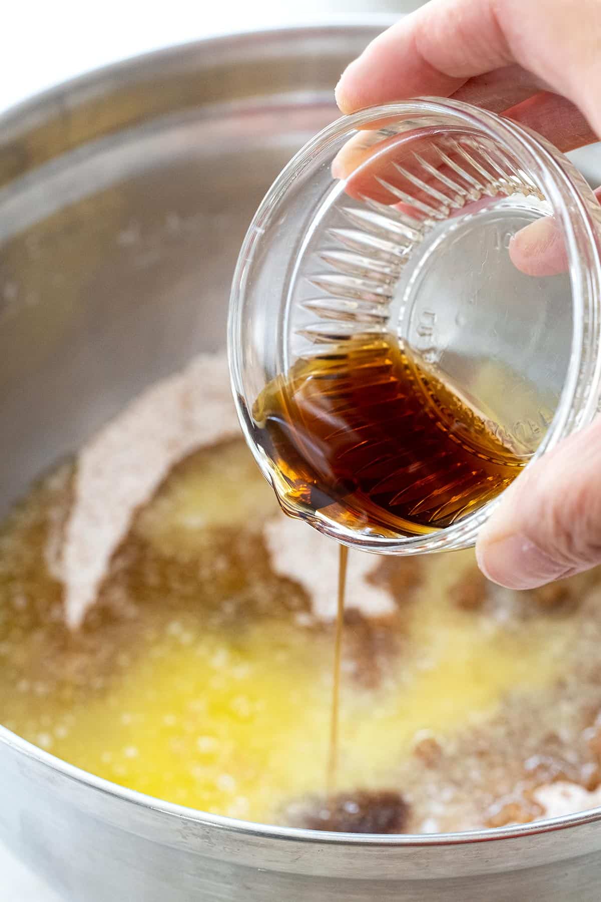 Pouring vanilla into a bowl.