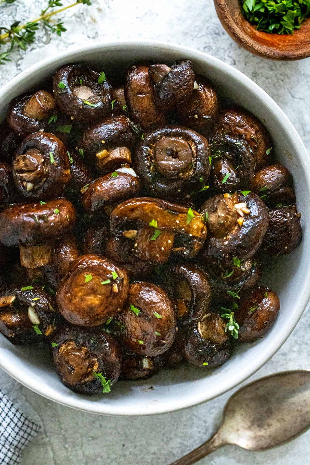 Roasted mushrooms served in a white bowl.