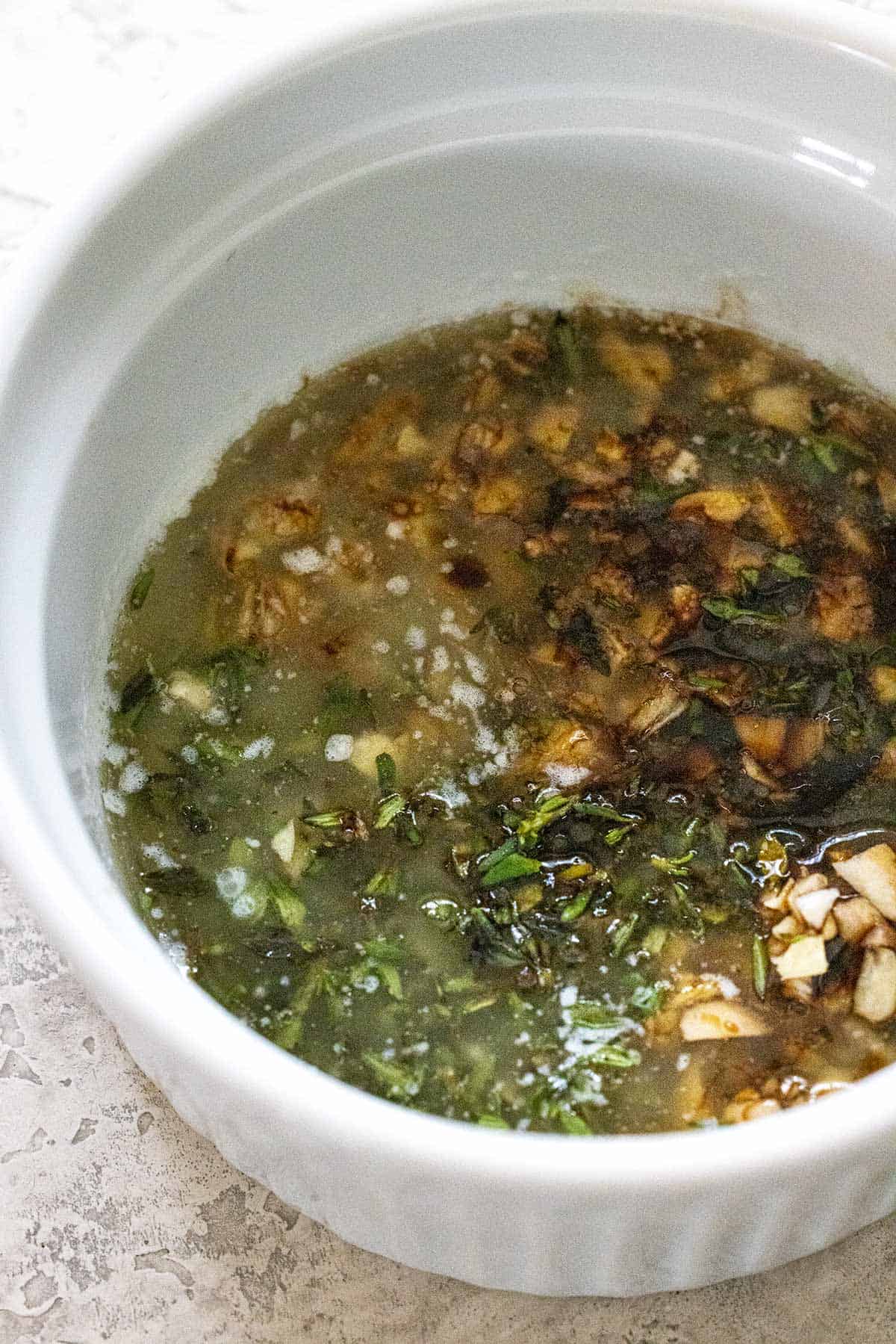 Butter garlic mixture in a white bowl.