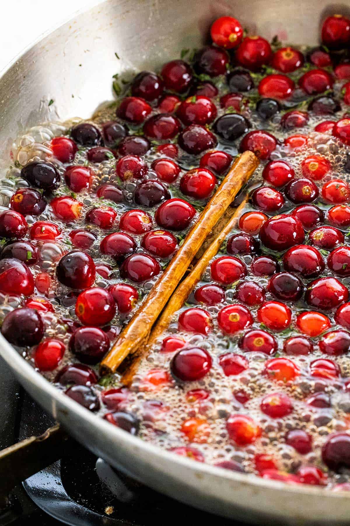 Cooking cranberries in a pan.