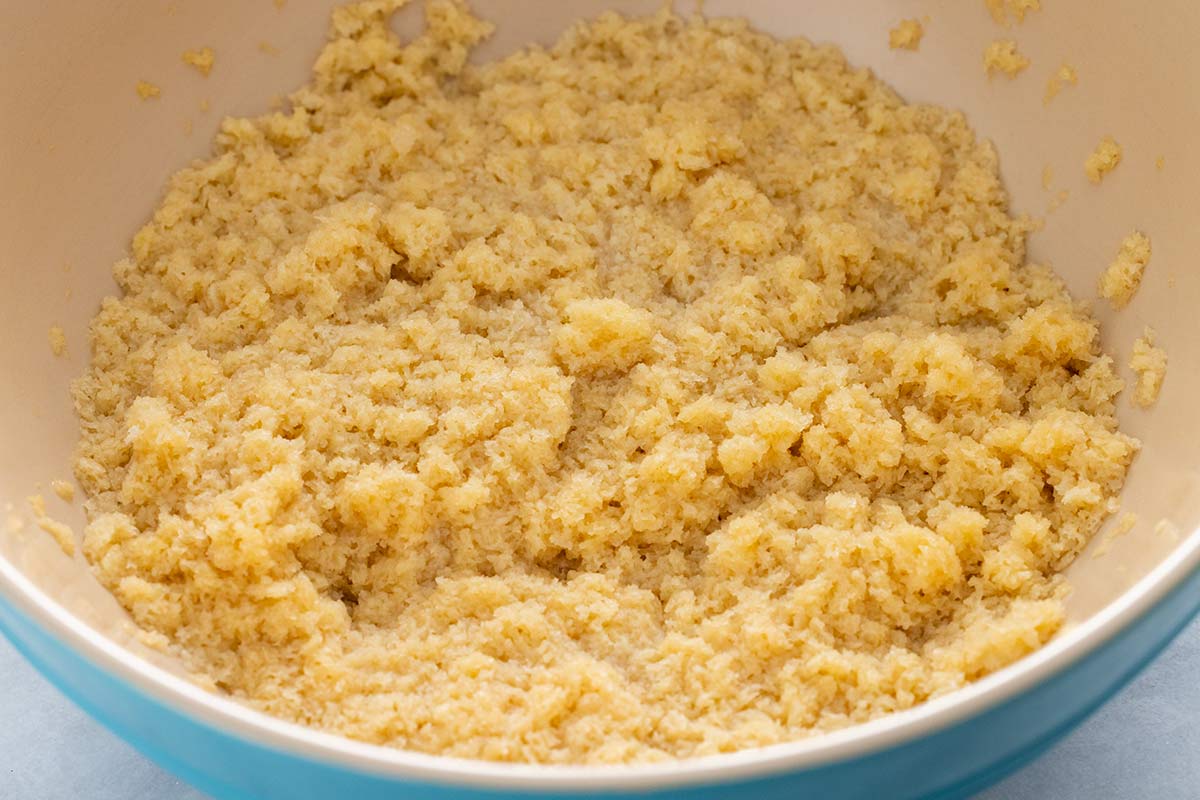 Mixed panade paste made of panko breadcrumbs, egg, and broth in a bowl.