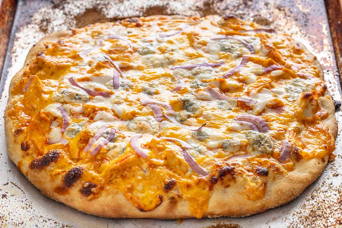 Buffalo chicken pizza on a sheet pan hot from the oven.