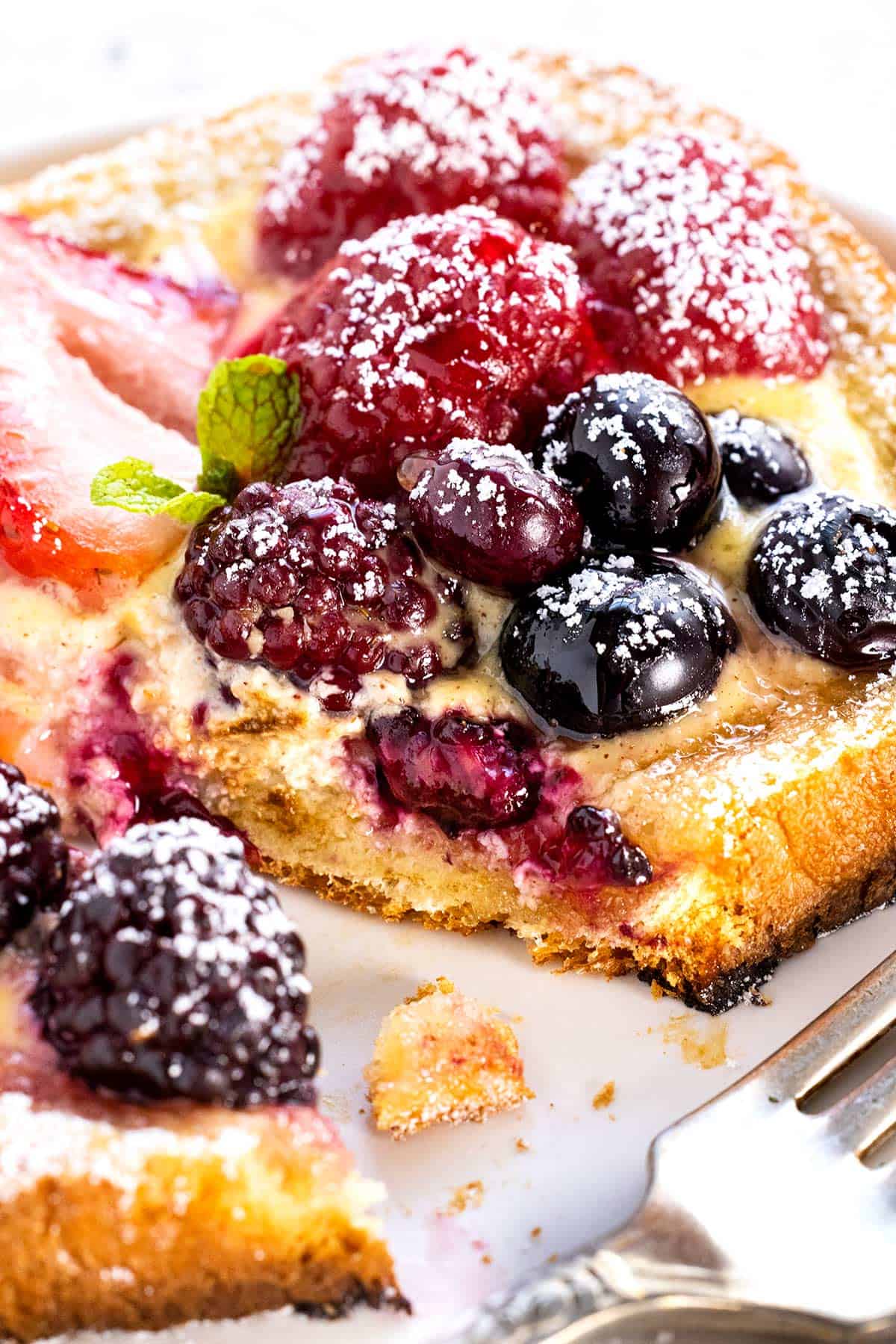 close up of fruit and custard on a slice of toast