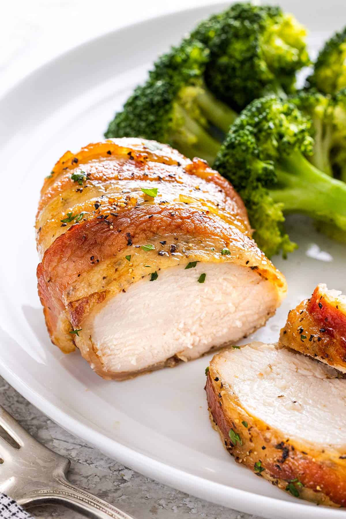 Chicken cut in half showing the white meat interior.