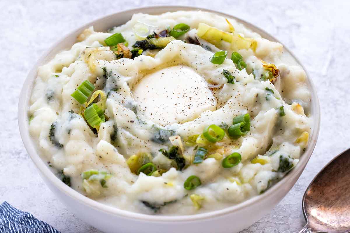 A bowl of colcannon with butter in the middle.