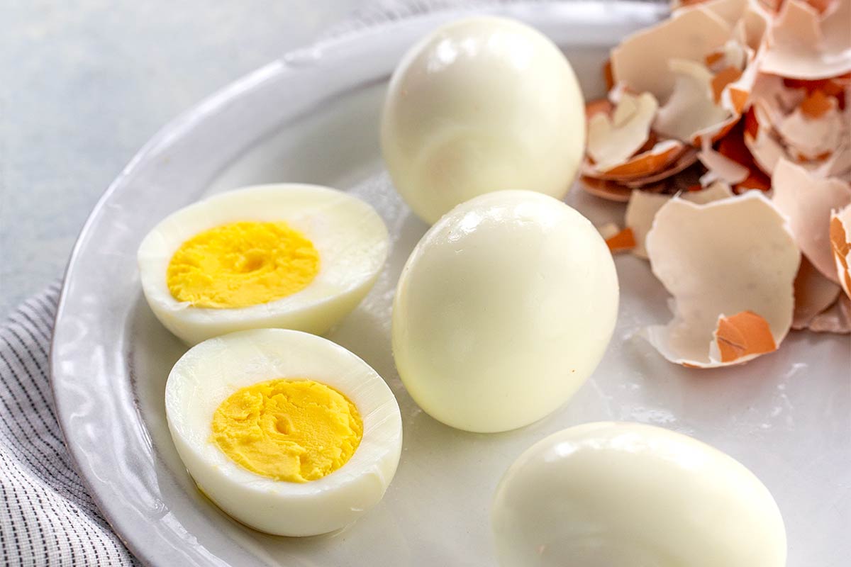 Hard boiled eggs on a plate with shells removed.