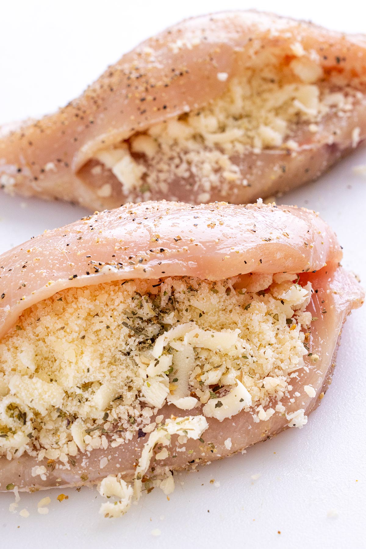 Two seasoned chicken breasts stuffed with parmesan and mozzarella cheeses.