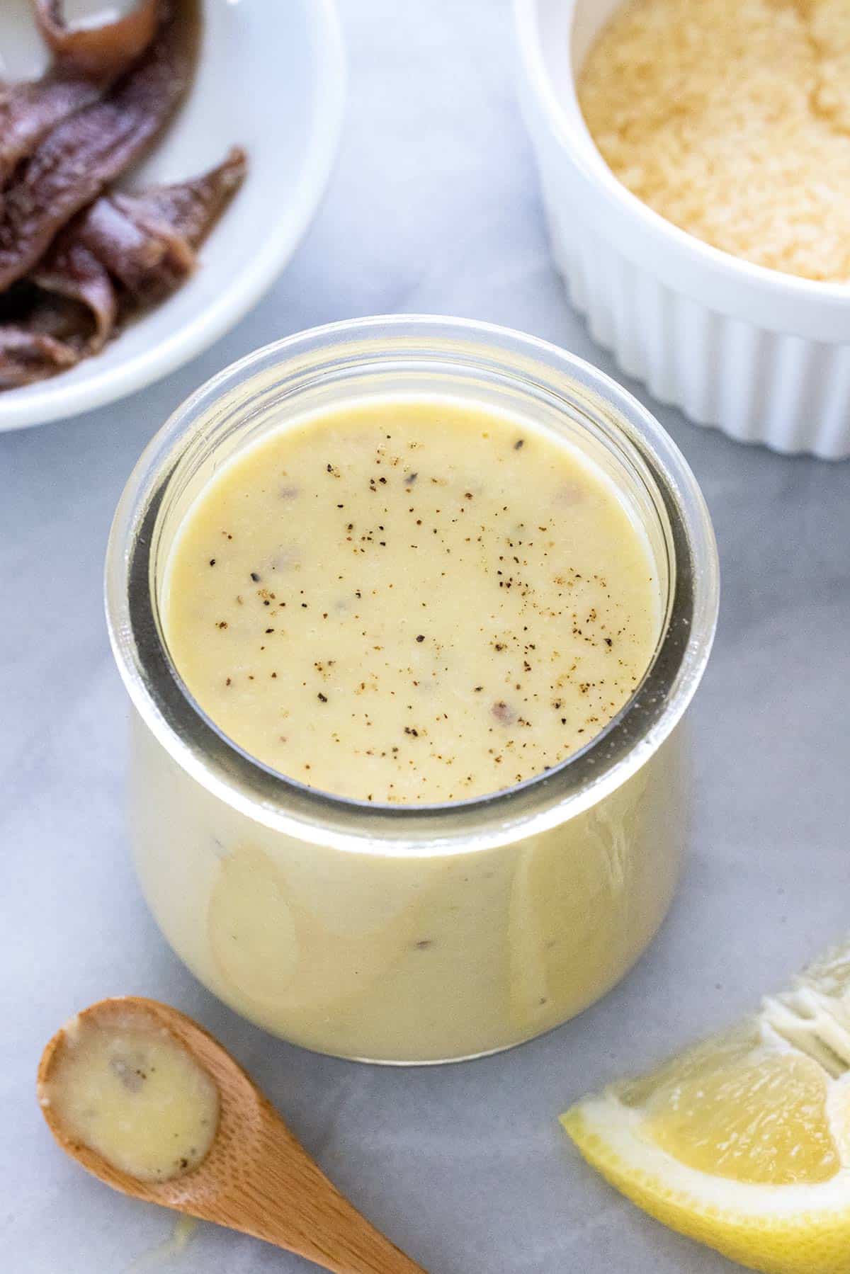 Homemade caesar dressing recipe placed in a glass jar.