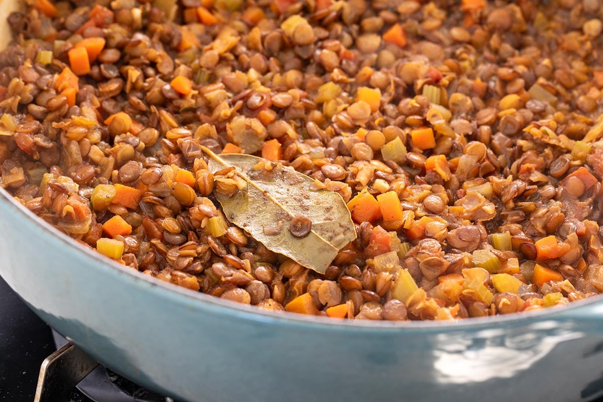 Brown lentils cooking in large dutch oven.