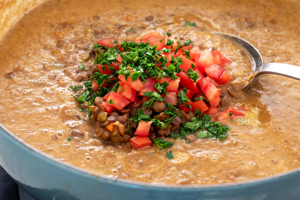 Whole pieces of lentils and tomatoes add texture to the soup.