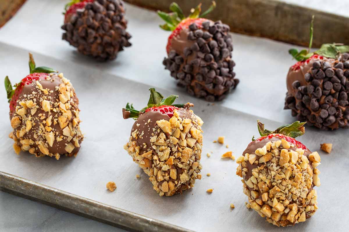 Chocolate covered strawberries dipped in nuts and chocolate chips.
