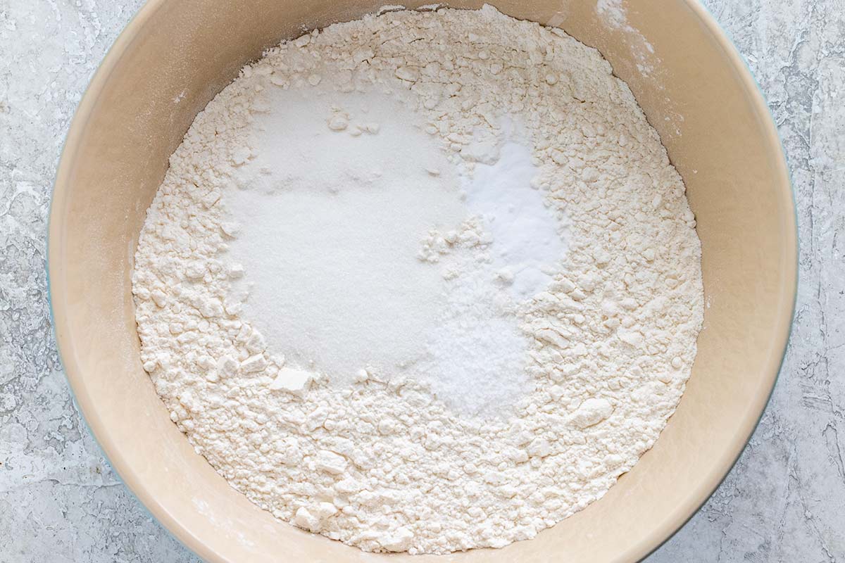 Bowl of flour, sugar, and baking soda about to be whisked.