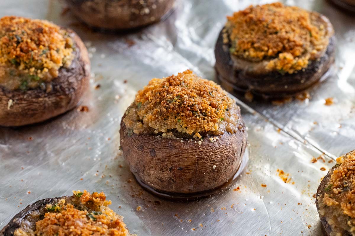 Baked stuff mushrooms with golden crispy bread crumb top.