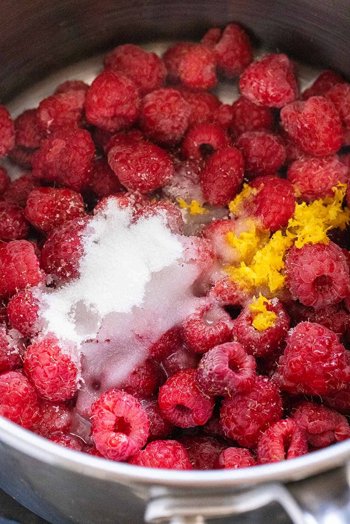 Raspberries, sugar, and lemon juice in a small saucepan.