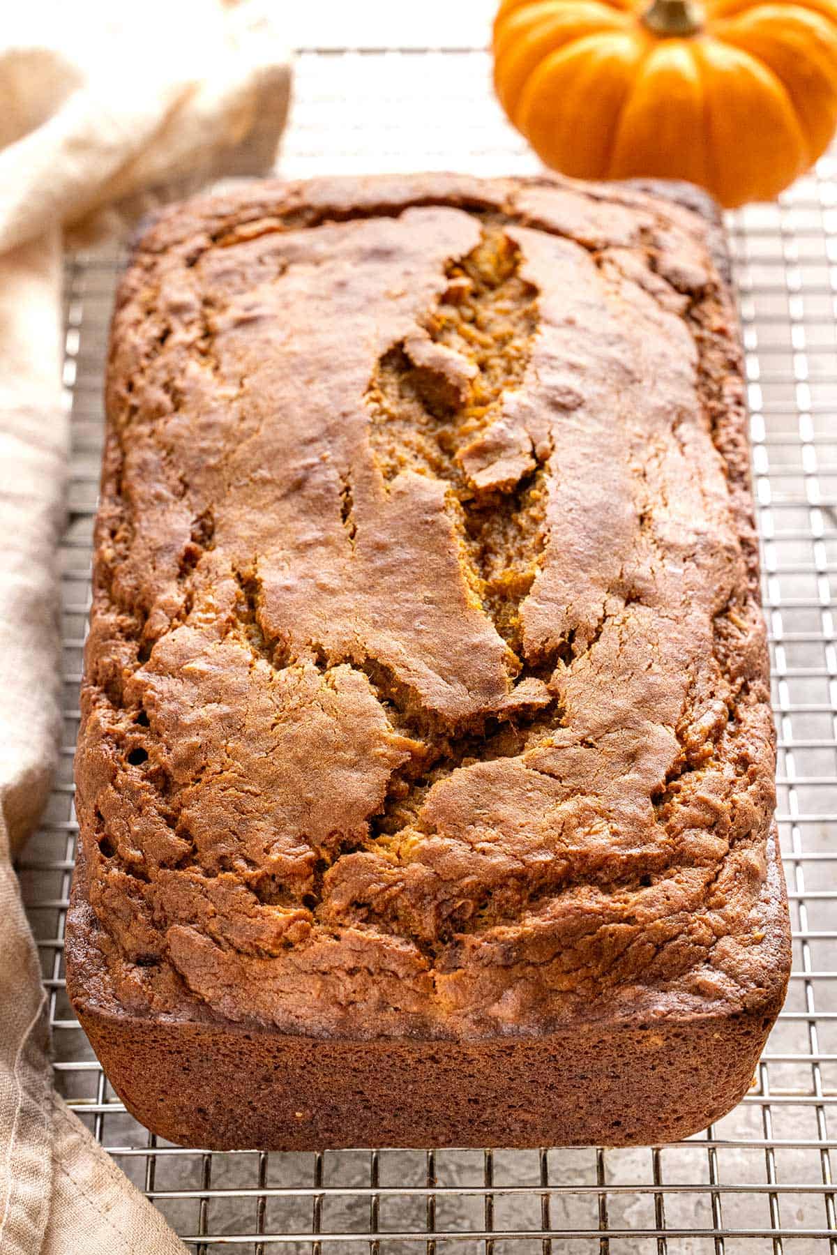 Freshly baked pumpkin banana bread cooling on a wire rack.